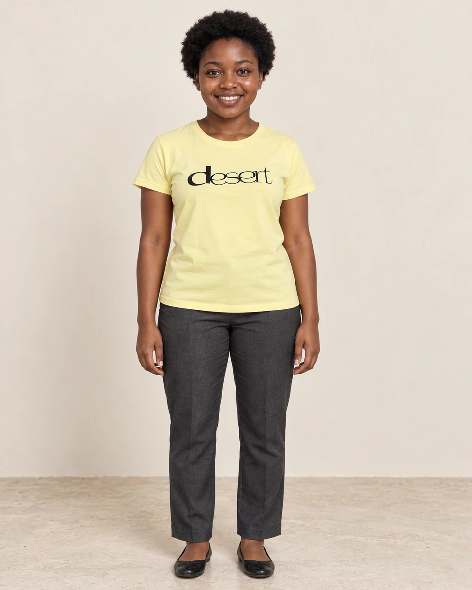Amani wearing a yellow tee with the black desert graphic in The Evening Edit campaign.