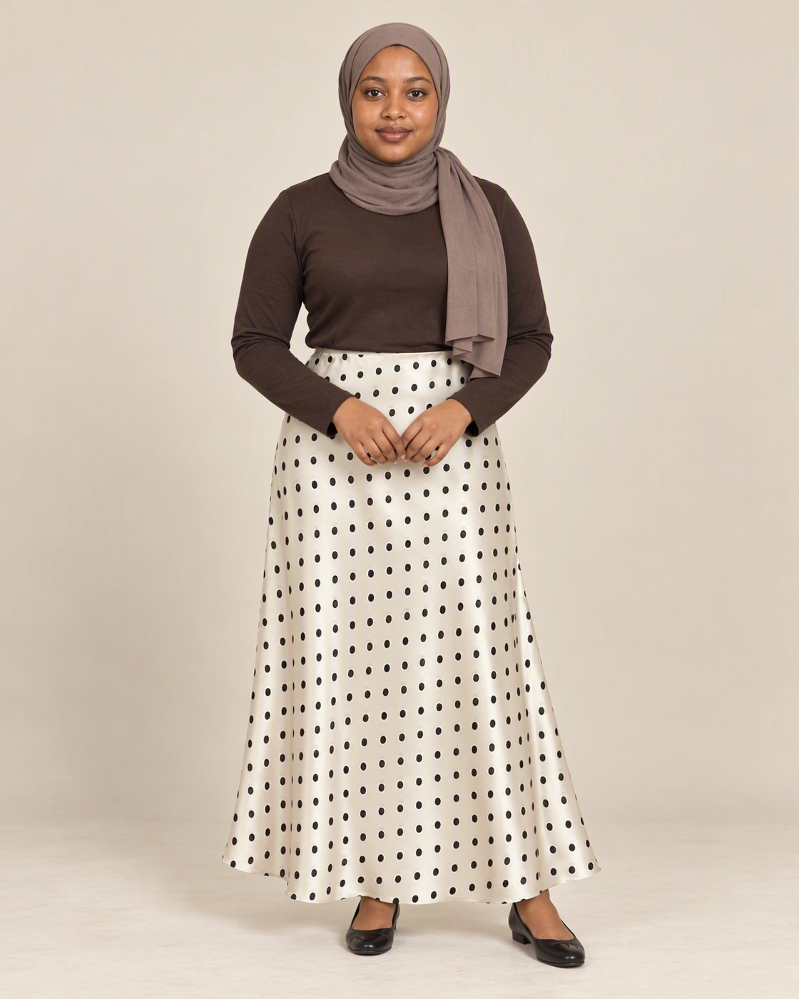 Halima wearing an ivory skirt with black polka dots in The Evening Edit campaign.